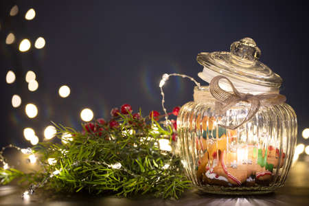 Christmas moody style background with candy jar and Christmas decoration on sparkling lightsの写真素材