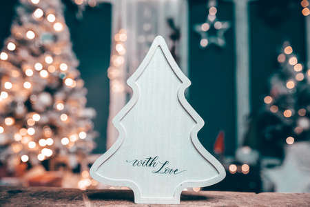 Winter, holidays and decoration concept - wooden christmas tree over sparkling holiday lightsの写真素材