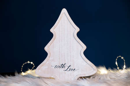 Winter, holidays and decoration concept - wooden christmas tree over sparkling holiday lightsの写真素材