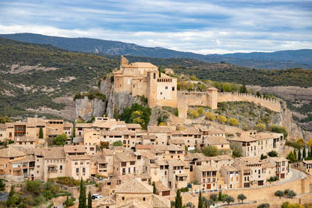 View of the typical spanish medieval village of Alquezar above Vera river in Aragon region, Huesca,...