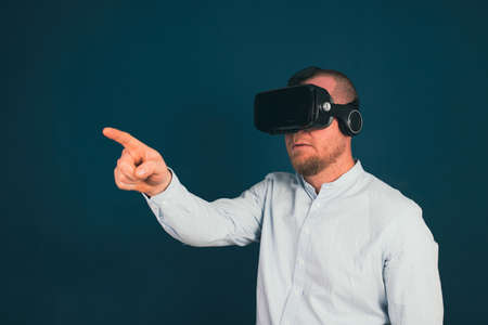 Metaverse digital cyber world technology. Businessman with VR glasses using AR augmented reality NFT, futuristic lifestyle conceptの写真素材