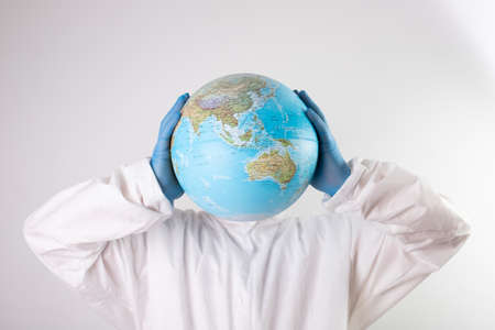 World epidemic danger concept.Male doctor with earth globe and top hat instead of head.の写真素材