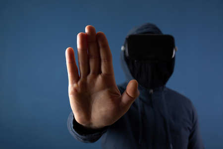 Metaverse digital cyber world technology. Man with VR glasses  playing AR augmented reality game and entertainment.NFT game futuristic lifestyleの写真素材