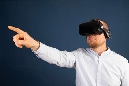 Metaverse digital cyber world technology. Businessman with VR glasses using AR augmented reality...