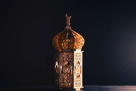 Ramadan Kareem background. Ornamental Arabic lantern glowing at night