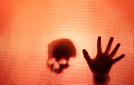 Horror ghost figure behind the matte glass. Halloween festival concept.の写真素材