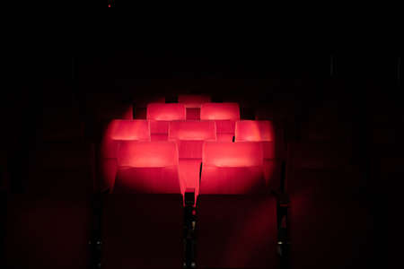 Emply red theatre seats with circle of spot light.の写真素材