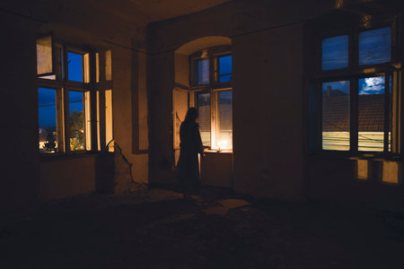 Ghost in abandoned, haunted house. Horror scene of scary spirit of a woman, halloween concept.の写真素材