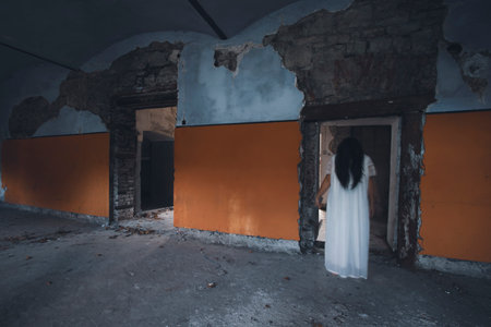 Ghost in abandoned, haunted house. Horror scene of scary spirit of a woman, halloween concept.の写真素材