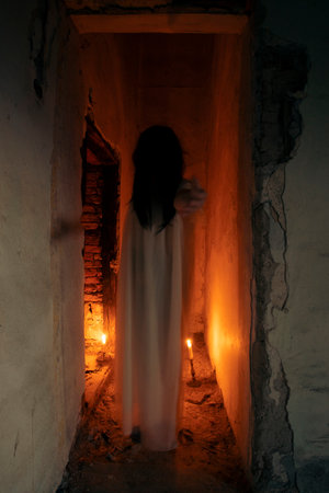 Ghost in abandoned, haunted house. Horror scene of scary spirit of a woman, halloween concept.の写真素材