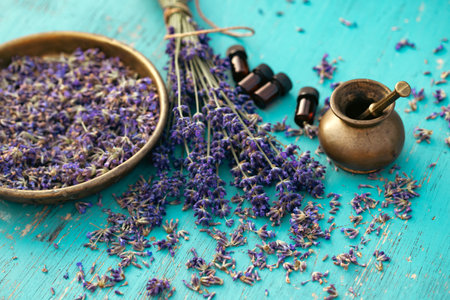 Bottle of Lavender essential oil with fresh lavender flowers on wooden rustic table. Aromatherapy, spa, massage concept.の写真素材