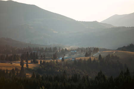 Magic summer sunset over the mountain village at Tihuta, Piatra Fantanele, Bistrita, Romaniaの写真素材