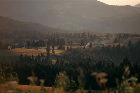 Magic summer sunset over the mountain village at Tihuta, Piatra Fantanele, Bistrita, Romaniaの写真素材