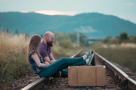Couple in love having fun on a railway track. The concept of travel, love and lifestyle.の写真素材