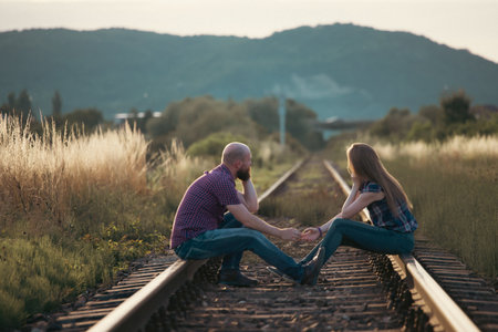 Couple in love having fun on a railway track. The concept of travel, love and lifestyle.の写真素材