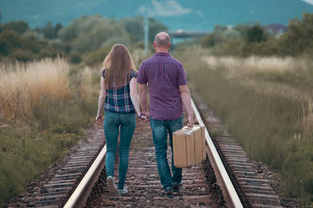 Couple in love having fun on a railway track. The concept of travel, love and lifestyle.の写真素材