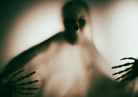 Horror skeleton or grim reaper behind the matte glass. Halloween festival concept.Blurred pictureの写真素材
