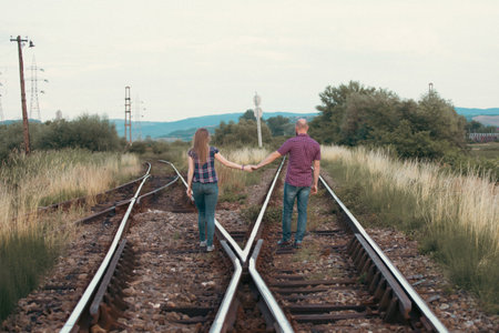 Couple in love having fun on a railway track. The concept of travel, love and lifestyle.の写真素材