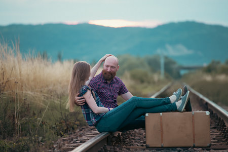 Couple in love having fun on a railway track. The concept of travel, love and lifestyle.の写真素材