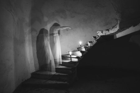 Ghost in abandoned, haunted house. Horror scene of scary spirit of a woman, halloween concept.の写真素材