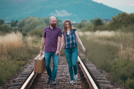 Couple in love having fun on a railway track. The concept of travel, love and lifestyle.の写真素材