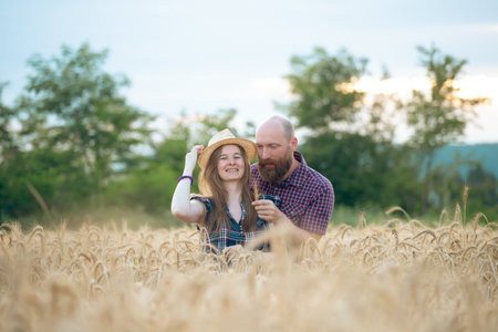 Couple having fun and enjoying relaxation in a wheat field. The concept of youth, love and lifestyle.の写真素材