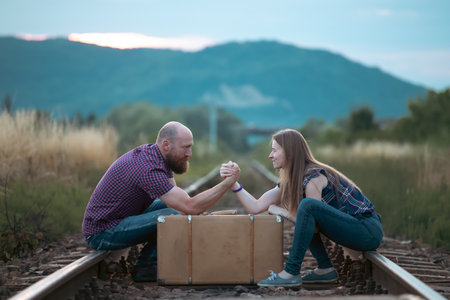 Couple in love having fun on a railway track. The concept of travel, love and lifestyle.の写真素材
