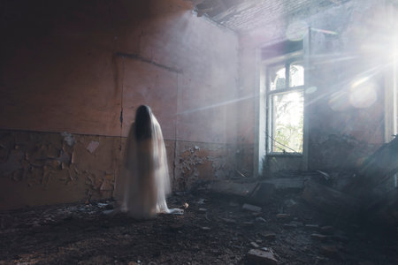 Ghost in abandoned, haunted house. Horror scene of scary spirit of a woman, halloween concept.の写真素材