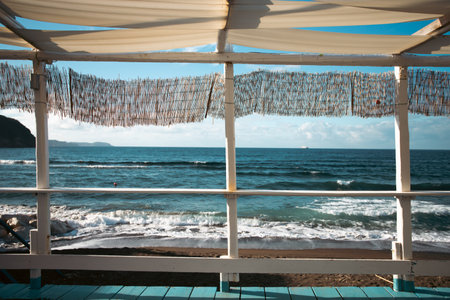 Cozy terrace on the beach, idyllic view of the seashore. Tropical summer vacation concept.の写真素材