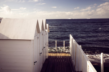 Traditional white wooden beach huts on the beach of Ciraccio, Procida island, Italyの写真素材