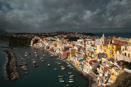 View of the Port of Corricella with lots of colorful houses on a sunny day in Procida Island, Italy.の写真素材