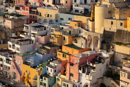 View of the Port of Corricella with lots of colorful houses in the sunset, Procida Island, Italy.の写真素材