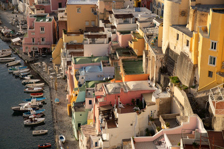 View of the Port of Corricella with lots of colorful houses in the sunset, Procida Island, Italy.の写真素材