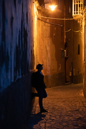 Tiny narrow streets with colorful houses at night on Procida Island, Italy.の写真素材