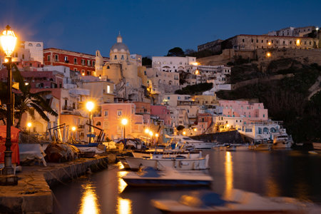 View of the Port of Corricella with lots of colorful houses at night in Procida Island, Italy.の写真素材