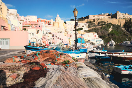View of the Port of Corricella with lots of colorful houses on a sunny day in Procida Island, Italy.の写真素材