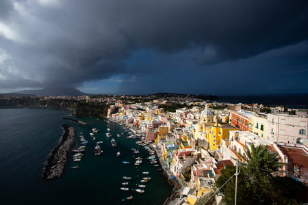 View of the Port of Corricella with lots of colorful houses on a sunny day in Procida Island, Italy.の写真素材