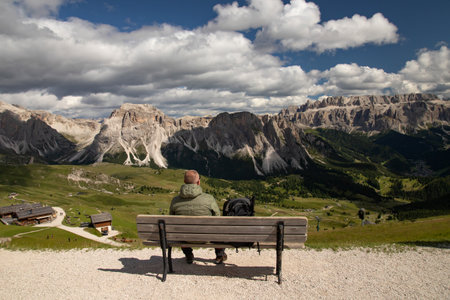 Young man resting in the Dolomites (Italy) on Seceda mountain, on a summer day.の写真素材