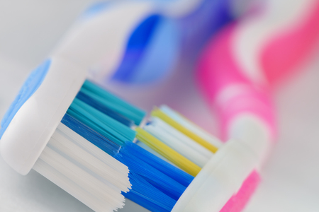 a coupe of toothbrushes lying together on white backgroundの写真素材