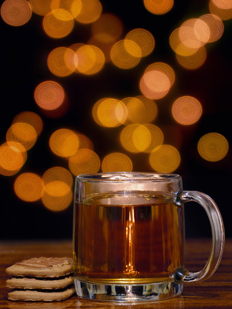 cozy cup of tea with cookies and bokeh backgroundの写真素材