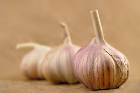Close-up of three garlic bulbs on blurry backgroundの写真素材