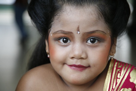 JAKARTA, INDONESIA - JULY 23, 2006: Young Balinese dancer is posing after performing her traditional...