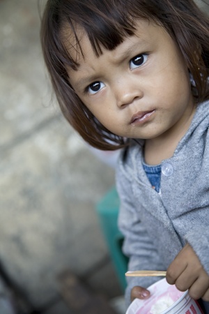 JAKARTA, INDONESIA - AUGUST 2, 2006: Young Indonesian girl enjoys ice cream on the street on August 2, 2006 in Kota Jakarta. のeditorial素材