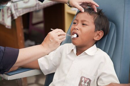 YOGYAKARTA, INDONESIA - AUGUST 4, 2006: tooth extraction in medical camp near Yogyakarta on August 4, 2006 in Jetis District, Bantul Regency of Indonesiaのeditorial素材