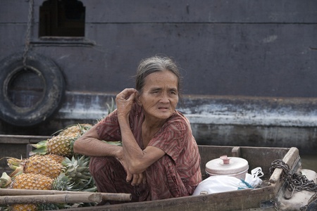 CAN THO, VIETNAM - DECEMBER 6, 2012: Unidentified old Vietnamese woman in her boat at the Floating Market in Can Tho, december 6, 2012 in Vietnam. のeditorial素材