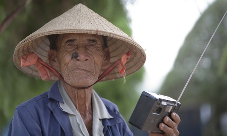CAN THO, VIETNAM - DECEMBER 6, 2012: Unidentified Vietnamese old man listening to the radio in Can Tho, december 6, 2012 in Vietnam. のeditorial素材