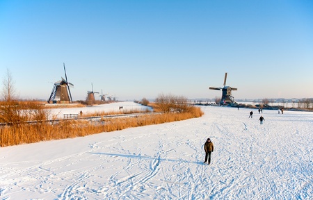 KINDERDIJK - FEBRUARY 4, 2012: Start of the skating period in the Netherlands at the Dutch historic windmills in Kinderdijk, february 4, 2012 in the Netherlandsのeditorial素材