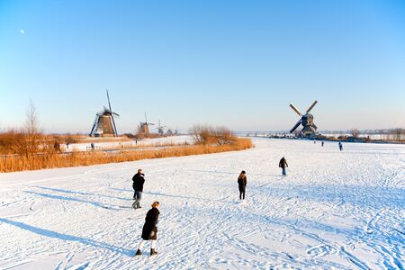 KINDERDIJK - FEBRUARY 4, 2012: Start of the skating period in the Netherlands at the Dutch historic windmills in Kinderdijk, february 4, 2012 in the Netherlandsのeditorial素材