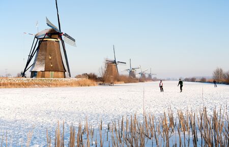 KINDERDIJK - FEBRUARY 4, 2012: Start of the skating period in the Netherlands at the Dutch historic windmills in Kinderdijk, february 4, 2012 in the Netherlandsのeditorial素材