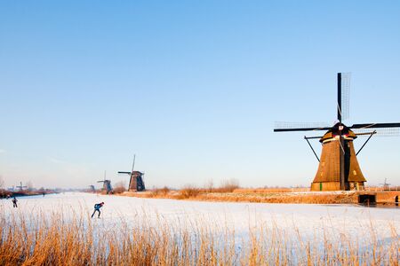 KINDERDIJK - FEBRUARY 4, 2012: Start of the skating period in the Netherlands at the Dutch historic windmills in Kinderdijk, february 4, 2012 in the Netherlandsのeditorial素材
